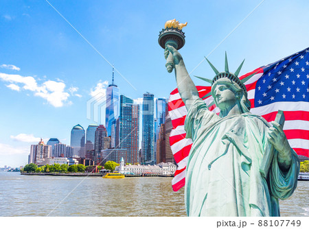 Statue of Liberty with a large american flag and New York skyline in the background Statue of Liberty with a large american flag and New York skyline in the background 88107749