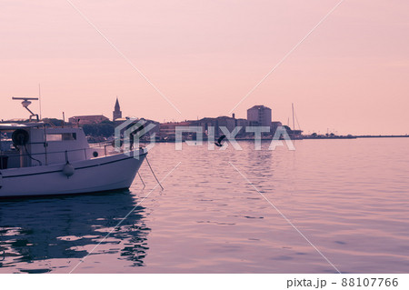 A photograph of a ship and a luxury yacht anchored in port. Beautiful photo of a Mediterranean port A photograph of a ship and a luxury yacht anchored in port. Beautiful photo of a Mediterranean port 88107766