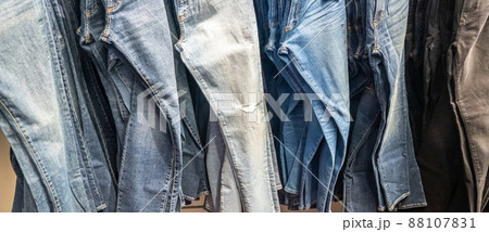 Jeans hanging on a rack. Row of denim pants. concept of buy, sell , shopping and jeans fashion 88107831