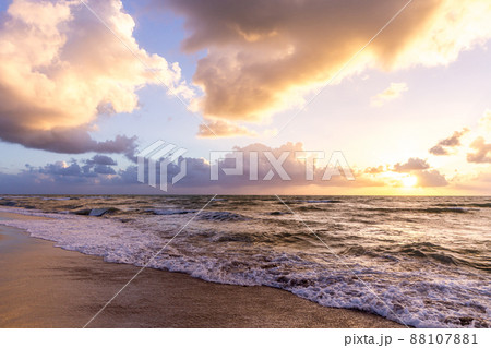 Beautiful cloud coastline background. Fiery orange sunset sky. Amazing sunrise on the beach in Miami. Fantastic landscape when sun setting over horizon on a cloudy day. Beautiful cloud coastline background. Fiery orange sunset sky. Amazing sunrise on the beach in Miami. Fantastic landscape when sun setting over horizon on a cloudy day. 88107881