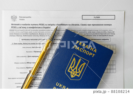 PESEL document, Ukrainian passport and a pen on white table background. PESEL document, Ukrainian passport and a pen on white table background. 88108214