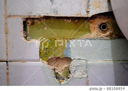 Selective focus, broken, destroyed ceramic tiles of the bathroom in an abandoned apartment close-up Selective focus, broken, destroyed ceramic tiles of the bathroom in an abandoned apartment close-up 88108954