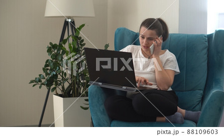 Authentic Young Woman Chatting On Phone In Living Room. Writing Searching Using IT. Happy Lady Working On Smartphone Browsing Internet On Comfortale Easy Chair. Buisenes, Education, Technology Concept 88109603