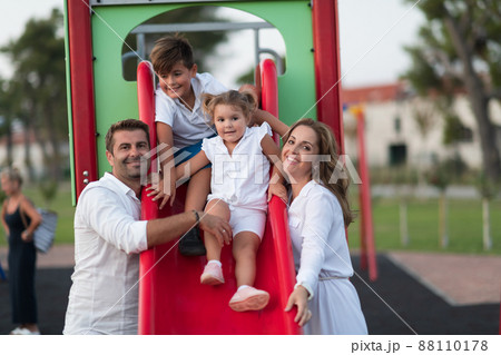 Senior couple in casual clothes with their children spending time in park a vacation together. Family time . Selective focus Senior couple in casual clothes with their children spending time in park a vacation together. Family time . Selective focus 88110178