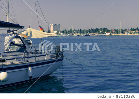 A photograph of a ship and a luxury yacht anchored in port. Beautiful photo of a Mediterranean port A photograph of a ship and a luxury yacht anchored in port. Beautiful photo of a Mediterranean port 88110236