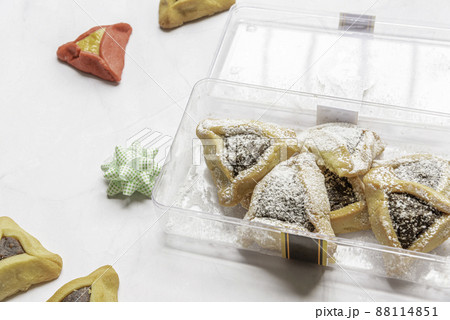 Purim celebration concept, jewish carnival holiday. Traditional hamantaschen cookies over white wooden table 88114851