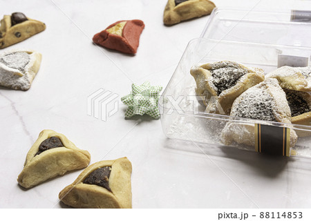 Purim celebration concept, jewish carnival holiday. Traditional hamantaschen cookies over white wooden table 88114853