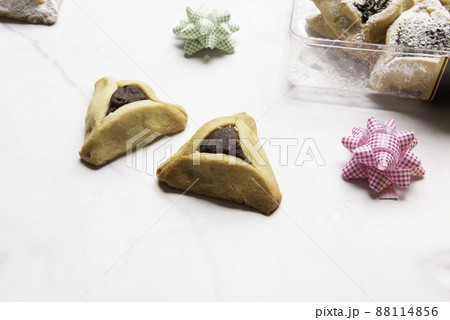 Purim celebration concept, jewish carnival holiday. Traditional hamantaschen cookies over white wooden table 88114856