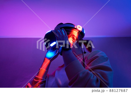 Woman interacts with virtual reality using a vr headset. Woman interacts with virtual reality using a vr headset. 88127687