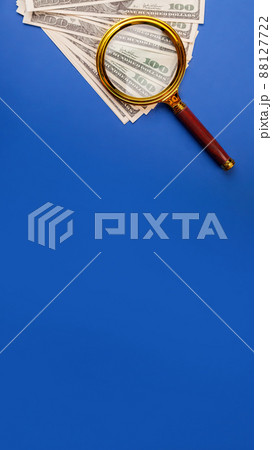 Money with a magnifying glass. Tax, return search or financial r 88127722