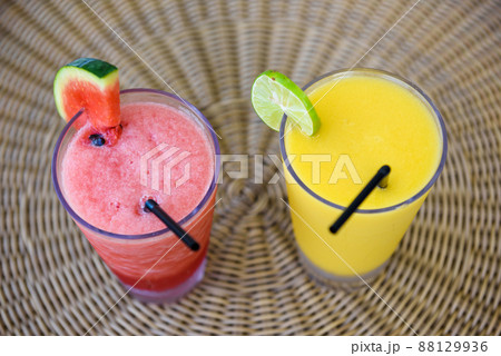 Watermelon and orange juice smootie in glass cups Watermelon and orange juice smootie in glass cups 88129936
