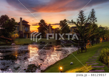 France houses and garden by the pond with twilight sky at dusk 88129937