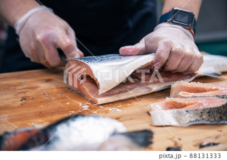 Chef preparing a salmon fish 88131333