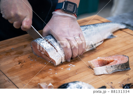 Chef preparing a salmon fish 88131334