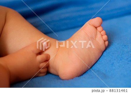 Children's legs on a blue veil close-up 88131461