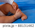 Baby legs on the bed 88131462