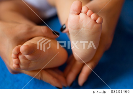 Hands of mother in the form of a heart on children's legs Hands of mother in the form of a heart on children's legs 88131466