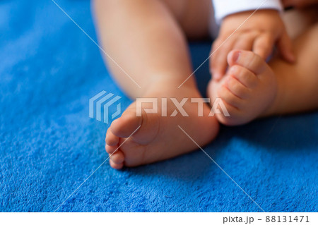 Children's legs on a blue veil close-up Children's legs on a blue veil close-up 88131471