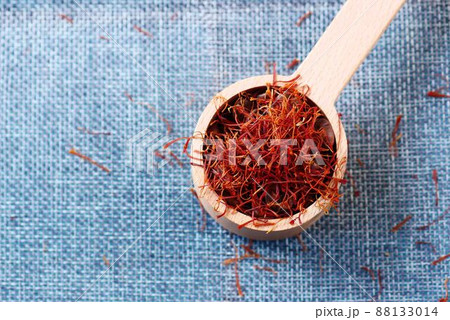 Saffron Spice in a wooden spoon on table cloth Saffron Spice in a wooden spoon on table cloth 88133014