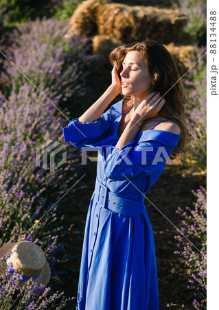 Attractive sensual young woman posing in a lavender field. Attractive sensual young woman posing in a lavender field. 88134488