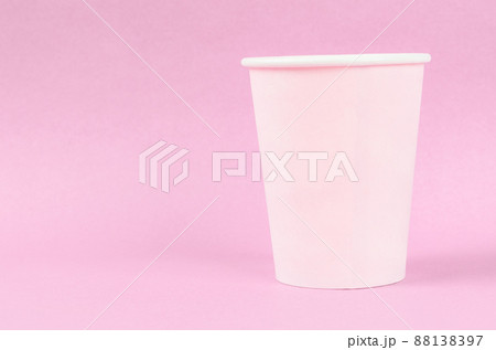Pink disposable paper cups on pink background. 88138397