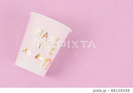 Wording Make time to enjoy on pink paper cup. 88138398
