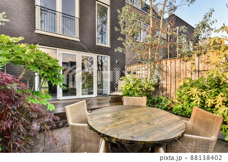 The backyard of a modern house with wooden floors and a small sitting area 88138402