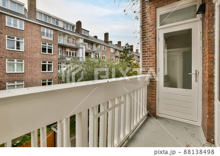 A balcony with a wooden fence and a view of nature inside the city A balcony with a wooden fence and a view of nature inside the city 88138498