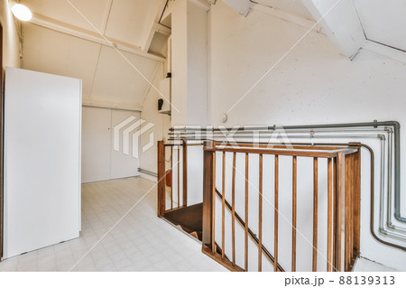 A mind-blowing room with a wooden staircase and a wardrobe A mind-blowing room with a wooden staircase and a wardrobe 88139313