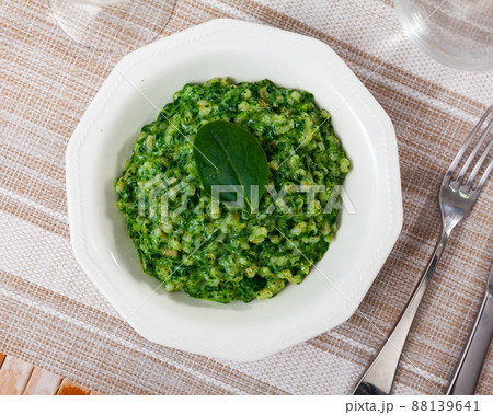 Portion of boiled pearl barley with spinach 88139641