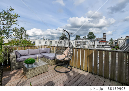 Graceful terrace with beautiful furniture and a cozy atmosphere in the open air Graceful terrace with beautiful furniture and a cozy atmosphere in the open air 88139903