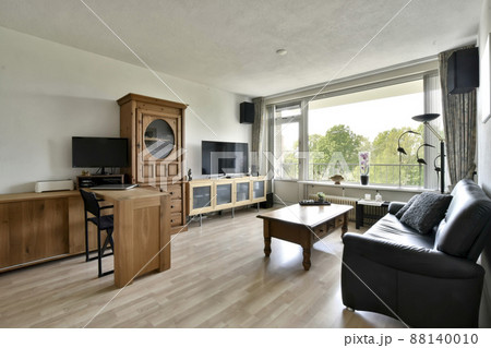 Living room combined with work area. Living room with wooden furniture and leather sofa 88140010