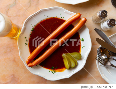 Pair of Viennese sausages with saft goulash on plate 88140197