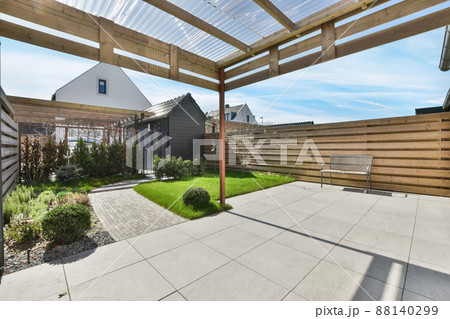 Cozy patio in the backyard of the house in pastel colors. garden with trees 88140299