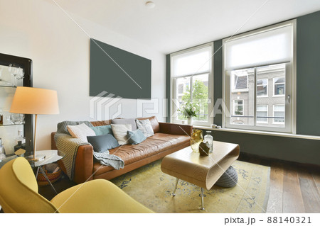 living room with bright furniture and casual leather sofa living room with bright furniture and casual leather sofa 88140321