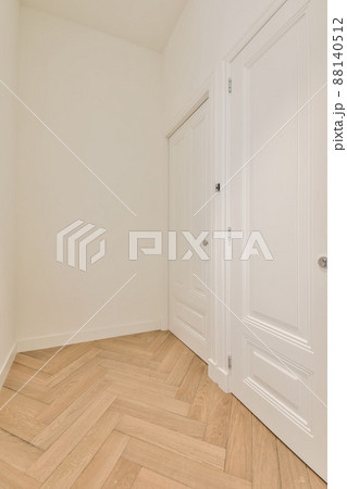 Corridor with parquet floors and white doors in a modern house 88140512