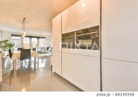 Kitchen with glossy white furniture and all appliances 88140566