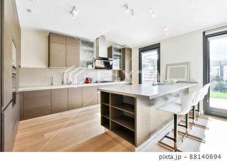 Luxurious kitchen from the island in a modern style and with all the necessary equipment for cooking Luxurious kitchen from the island in a modern style and with all the necessary equipment for cooking 88140694