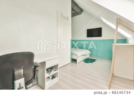 Modern room in the attic of a house with white furniture and white walls Modern room in the attic of a house with white furniture and white walls 88140734