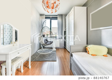 Interior of a spacious bedroom with a big wardrobe and comfortable armchair in a modern house 88140767