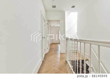 Luxurious corridor with white walls and classic white doors. Corridor with luxury stairs 88140949