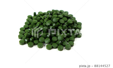 Spirulina algae tablets isolated on white background spinning to the left. Nutritional supplements, vitamins and health concept  88144527