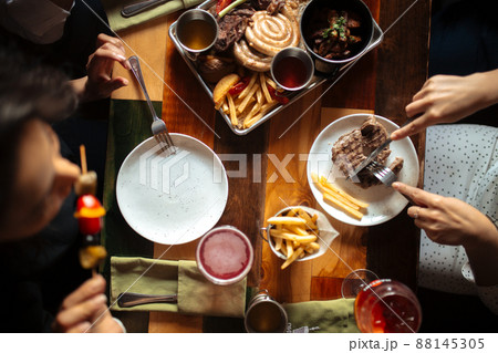 Dining table eating steak and appetizer 88145305