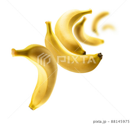 Yellow bananas levitate on a white background Yellow bananas levitate on a white background 88145975