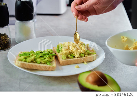 Woman prepare toasts with avocado, Healthy nutrition 88146126