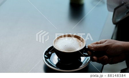 Hands about to grab hot coffee to drink. 88148384