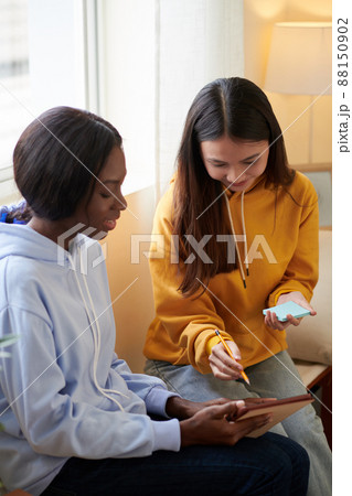 Friends Discussing Video on Tablet 88150902