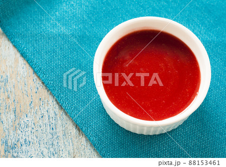 Red sauce in white on a blue background Red sauce in white on a blue background 88153461