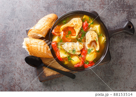 White fish stew with potatoes, peppers, tomatoes and onions close-up in a bowl. horizontal top view 88153514