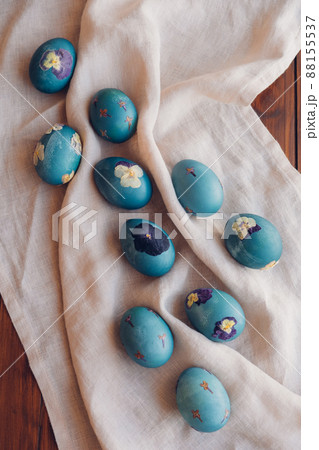 Pressed flower Easter eggs on beige tablecloth. Pressed flower Easter eggs on beige tablecloth. 88155537